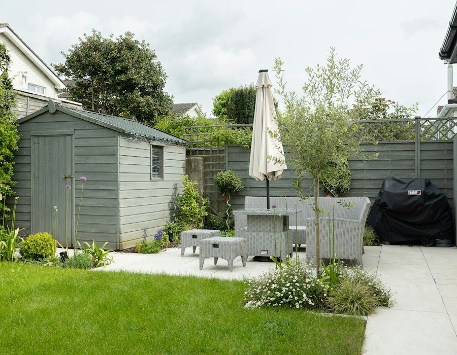 Landscaped backyard with patio seating and garden planting