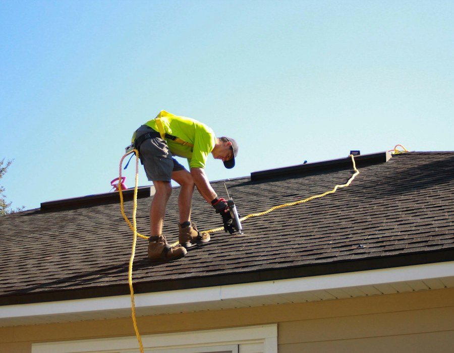Roofing specialist working on a residential shingle roof